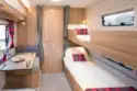 The cosy bunk “bedroom” is integrated with the dining area