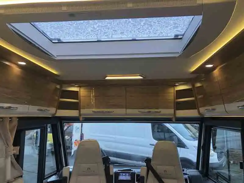 Cupboards over the windscreen is an unusual feature - picture courtesy of Oakwell Motorhomes (Click to view full screen)