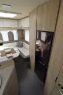 The rear lounge has a tall and slim fridge