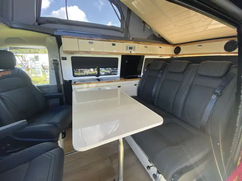 The lounge and table in the Knights Custom Prestige Tourer campervan (Click to view full screen)