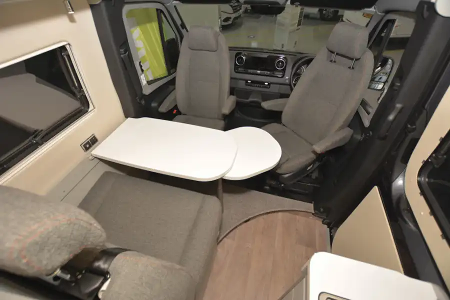 The living area with dining table in the Hymer Free 600 S campervan (Click to view full screen)