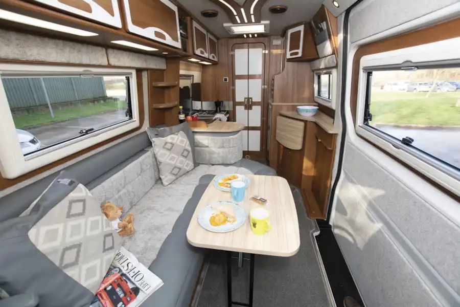 The lounge area with table out in the IH 680 CFL campervan (Click to view full screen)
