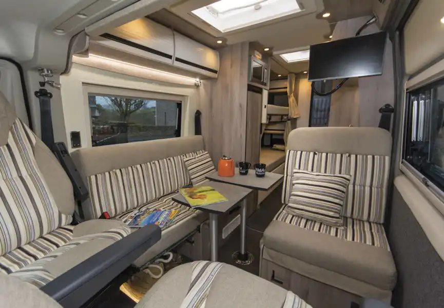 Seats and dining table in the WildAx Solaris XL campervan (Click to view full screen)