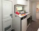 A combined grill and oven alongside the fridge