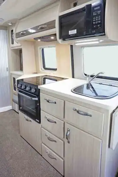 The kitchen includes microwave, oven and grill - picture courtesy of Auto-Sleepers (Click to view full screen)