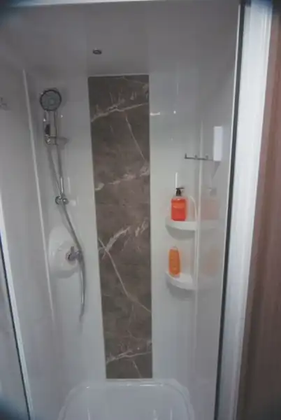 A stone effect panel in the shower is new (Click to view full screen)