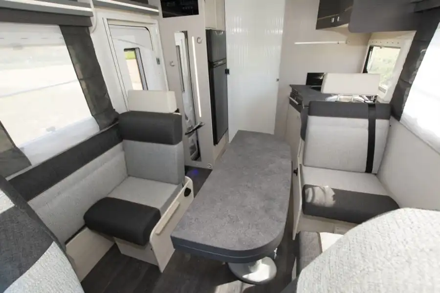 The interior of the Chausson 650 motorhome with travel seat showing (Click to view full screen)