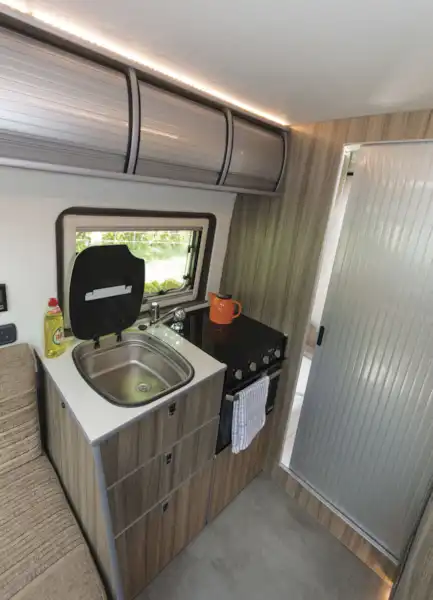 The practical kitchen in the The Axon Opportunity campervan  (Click to view full screen)