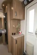 The cabient by the door contains TV connections