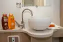 The circular washbasin looks so high-end domestic, sitting up on top of the cabinet