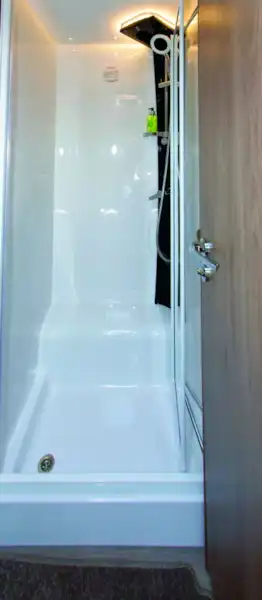 Bright, white light shines from above shower mounting (Click to view full screen)