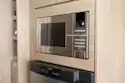 The microwave is above the fridge-freezer