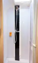 A large, square shower rose and a smart, black panel