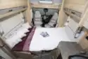 The front lounge converted to a bed in the Elddis Marquis Majestic 185 motorhome