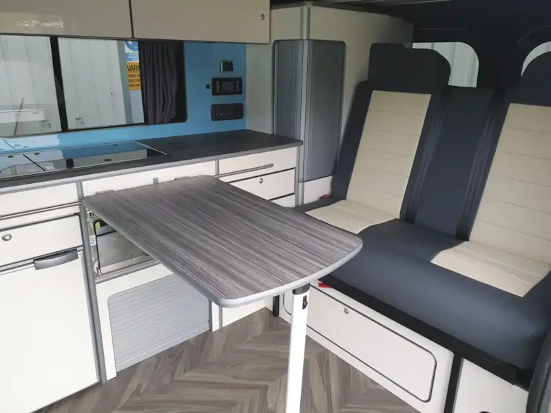Dining table and seats in the Calder Campers Renault Trafic Auto campervan (Click to view full screen)