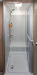 The shower walls and tray are stone effect