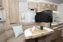 The lounge in Le Voyageur Classic LV7.8LU motorhome, with a flatscreen TV on display