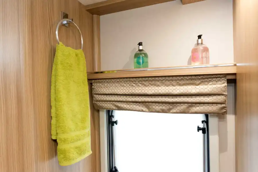 A towel loop and folded blind add interest to the window (Click to view full screen)
