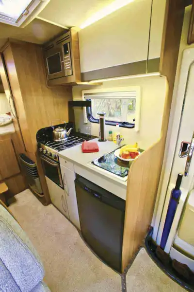 The kitchen is compact but well-equipped - spot the pop-up mains socket tower (Click to view full screen)