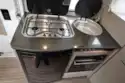 The kitchen includes a three-burner gas hob and a Thetford grill/oven